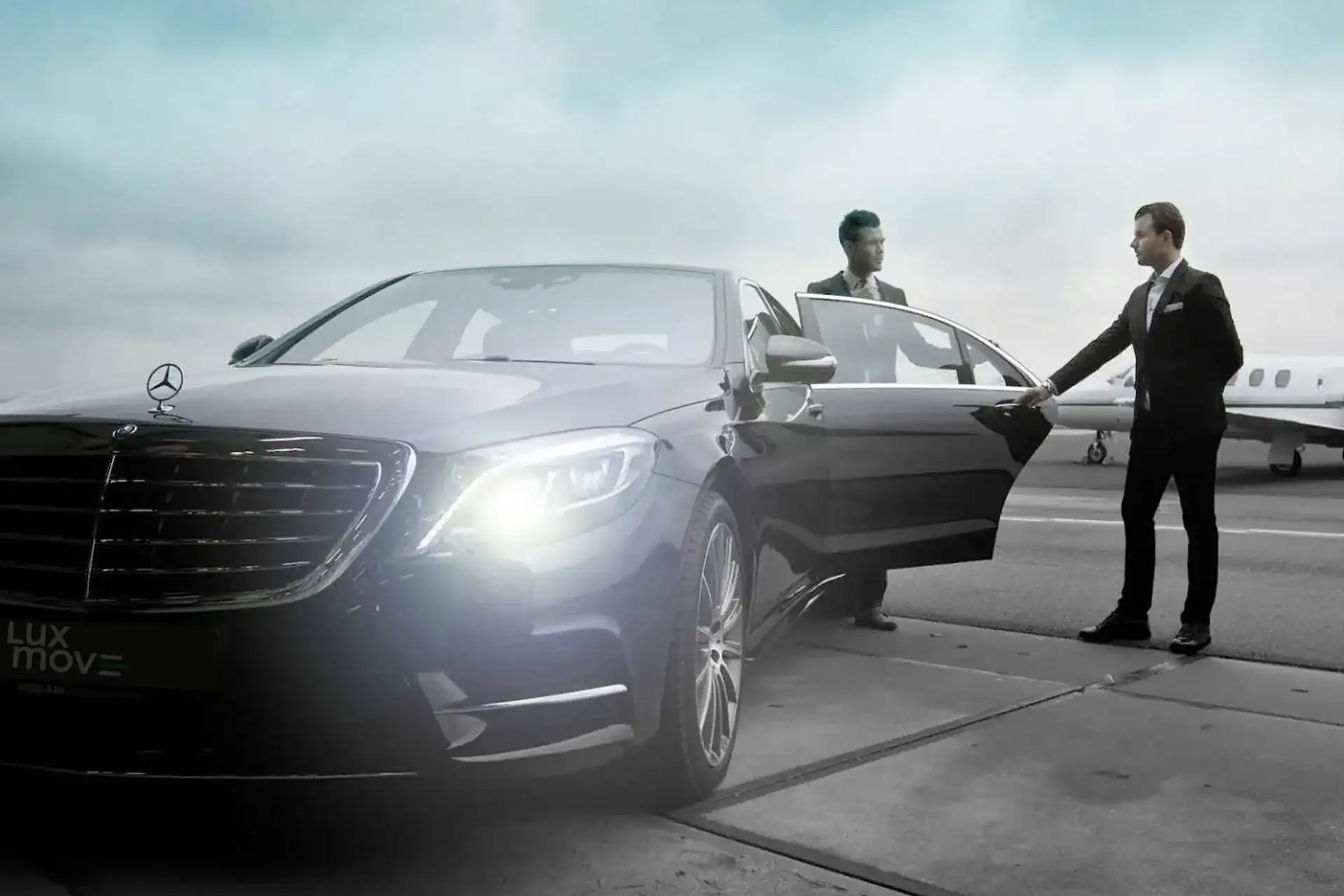 Professional chauffeur opening a Mercedes-Benz for a high-profile passenger during Bangkok luxury airport transfers.