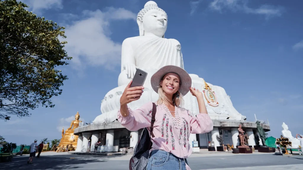 Tourist taking a selfie in front of Phuket’s Big Buddha after its official reopening.